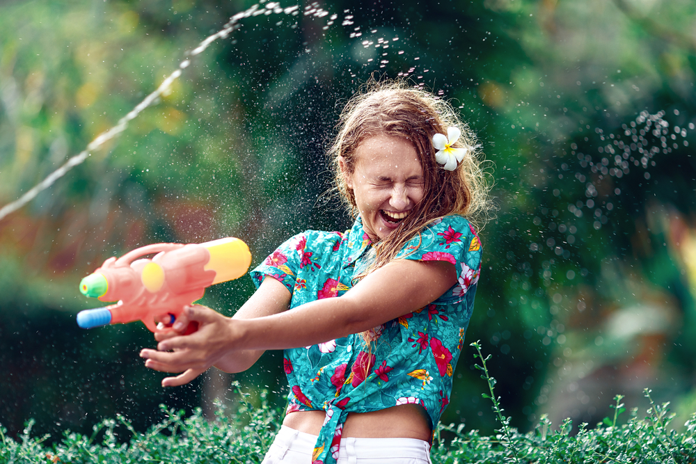 A picture of a young woman with a water pistol possibly partaking in the Polish Easter tradition known as 'Wet Monday'.