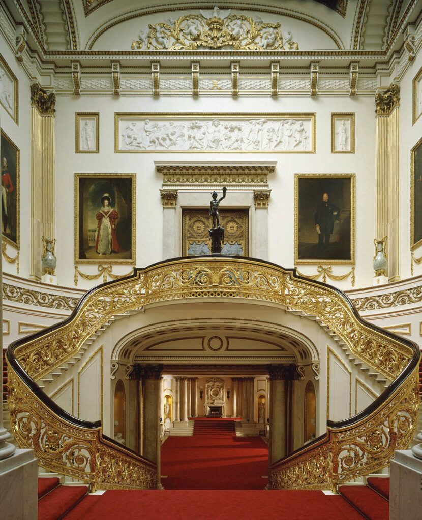 The resplendent Grand Staircase, full of intricate gold details and a red carpet.